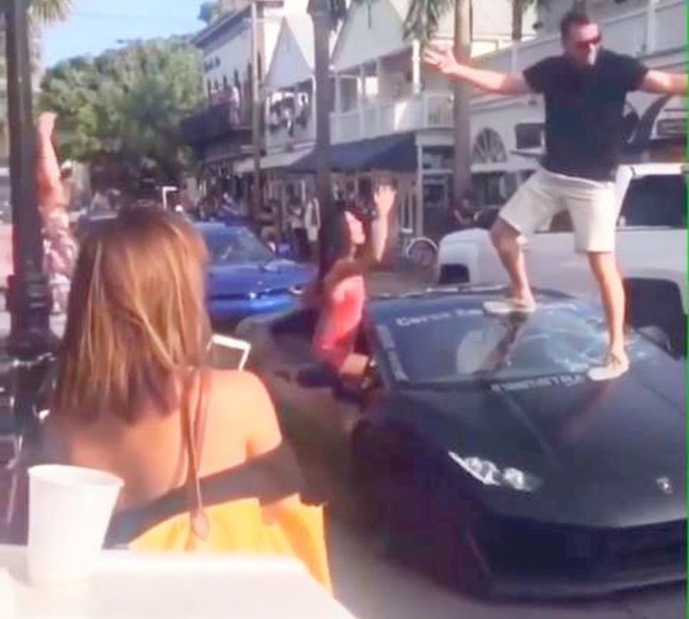 Guy stand on Lamborghini windshield